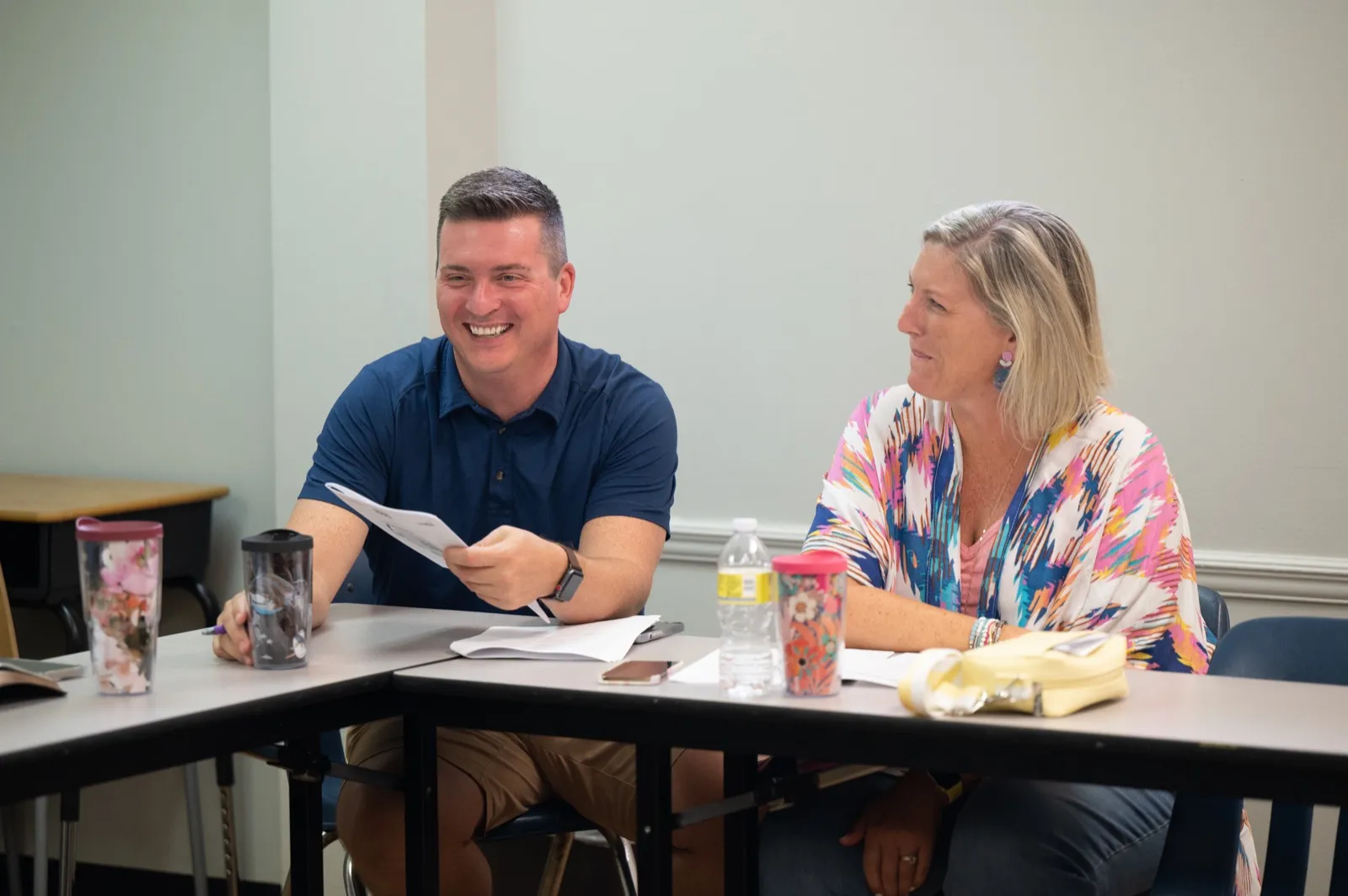 A man and woman laughing together during a small group meeting